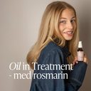 Ung kvinna med långt blont hår håller Green Heads Oil in Treatment med rosmarin i handen, omslagsbild till blogg om rosmarin i hårvård och hair oiling.